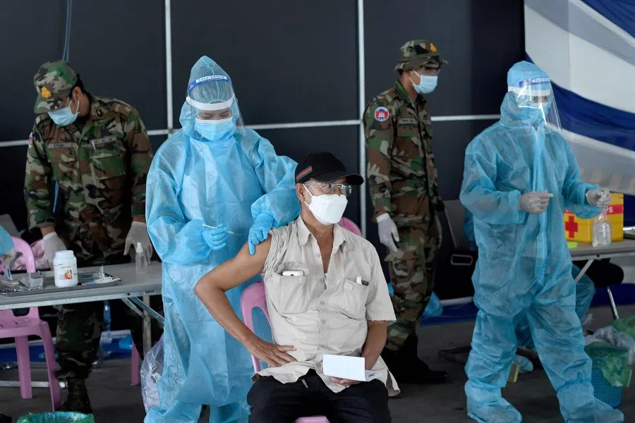 A man receives a dose of the Sinovac vaccine from China against the Covid-19 coronavirus at the Australian Centre for Education in Phnom Penh on 1 May 2021, as part of the government's campaign to halt the rising number of cases of the virus. (Photo by TANG CHHIN Sothy/AFP)