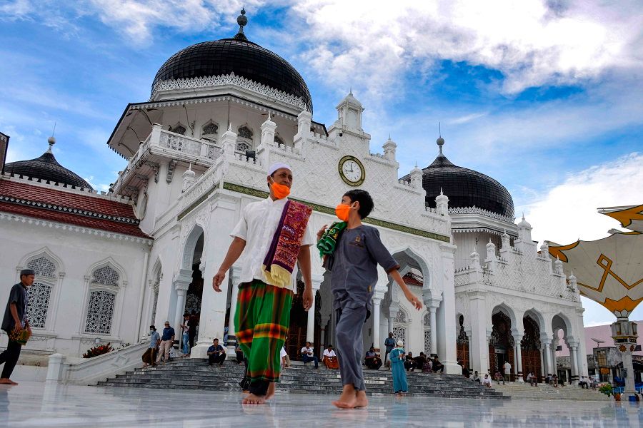 People leave the Baiturrahman grand mosque after taking part in the second Friday prayers during the Islamic holy month of Ramadan in Banda Aceh, Indonesia, on 1 May 2020. (Chaideer Mahyuddin/AFP)