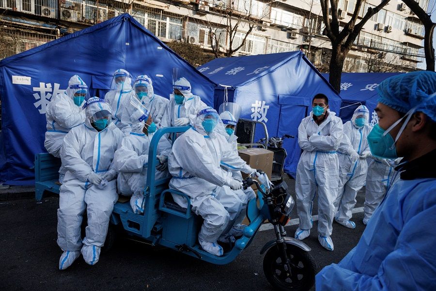 Pandemic prevention workers leave for their shift to look after buildings where residents do home quarantine, as Covid-19 outbreaks continue in Beijing, China, 8 December 2022. (Thomas Peter/Reuters)