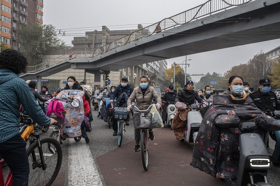 Morning commuters on a street in Beijing, China, on 5 November 2021. (Gilles Sabrie/Bloomberg)