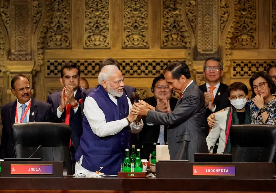 India's Prime Minister Narendra Modi and Indonesia's President Joko Widodo take part in the handover ceremony at the G20 Leaders' Summit, in Nusa Dua, Bali, Indonesia, 16 November 2022. (Willy Kurniawan/Reuters)