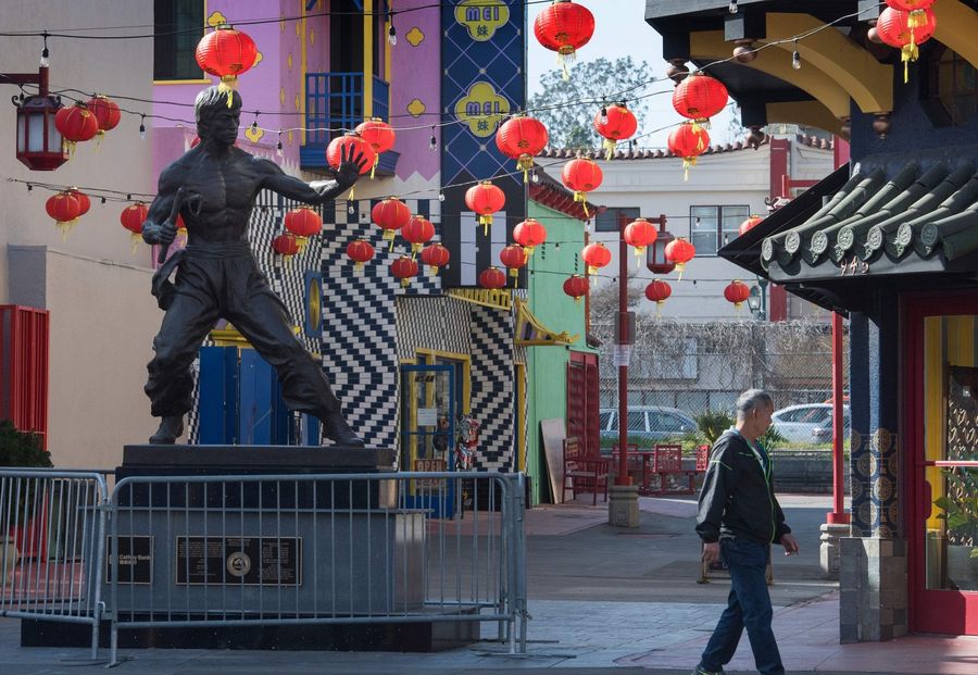 In this photo taken on 13 February 2020, a man walks by a deserted Los Angeles Chinatown as most stay away due to fear of the Covid-19 epidemic. (Mark Ralston/AFP)