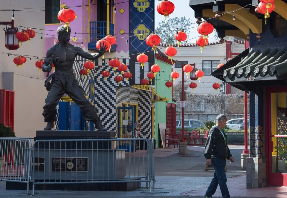 In this photo taken on 13 February 2020, a man walks by a deserted Los Angeles Chinatown as most stay away due to fear of the Covid-19 epidemic. (Mark Ralston/AFP)