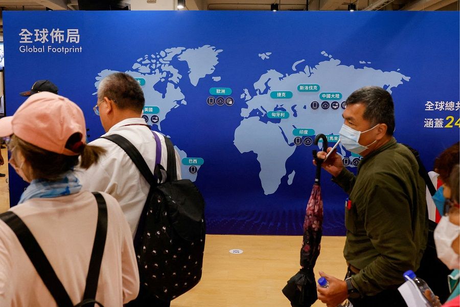 Shareholders of Taiwan's Foxconn walk past a map of Foxconn's businesses around the globe after the annual shareholder meeting in New Taipei City, Taiwan, on 31 May 2023. (Ann Wang/File Photo/Reuters)