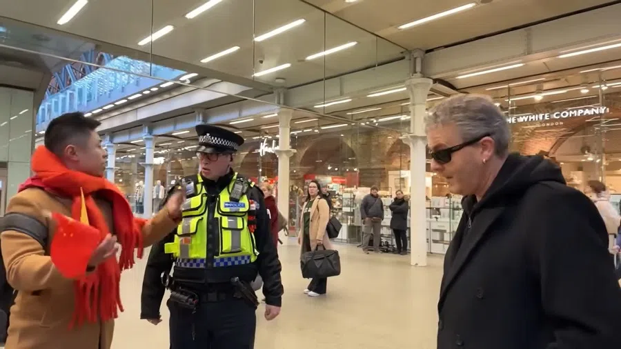 Screenshot of a video showing the argument between British pianist Brendan Kavanagh and a Chinese TV group, with the police entering the scene. (YouTube)
