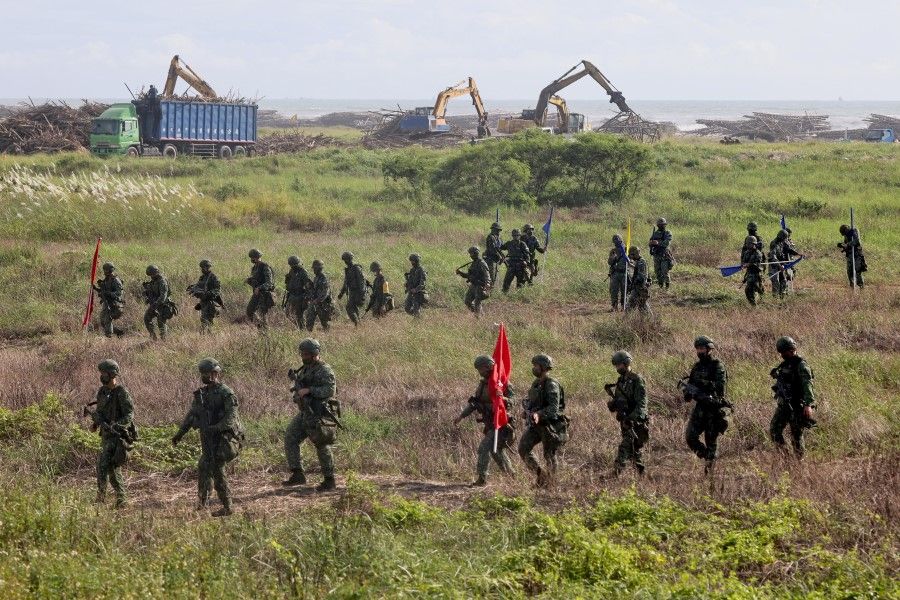 Soldiers walk back to base after an anti-invasion formation practice on the beach during the annual Han Kuang military drill in Tainan, Taiwan, 14 September 2021. (Ann Wang/Reuters)