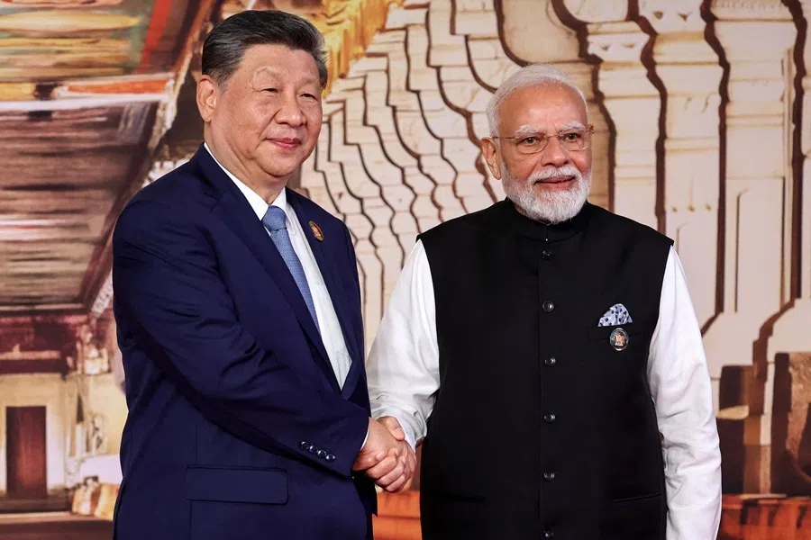 In this pool photograph distributed by the Russian state agency Sputnik, India's Prime Minister Narendra Modi (right) shakes hands with China's President Xi Jinping during a welcome ceremony before the start of the 18th BRICS Summit in New Delhi on 12 September 2026.