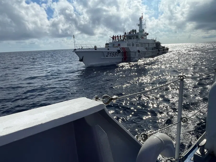 A China Coast Guard ship is seen approaching a Philippines Coast Guard vessel escorting a resupply mission for Philippine troops stationed at a grounded warship, in the South China Sea, 8 September 2023. (Jay Ereno/Reuters)