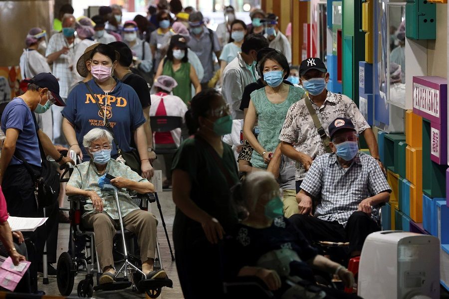 People wait during a vaccination session for elderly people over 85 years old at a school following the Covid-19 outbreak in Taipei, Taiwan, 15 June 2021. (Ann Wang/Reuters)