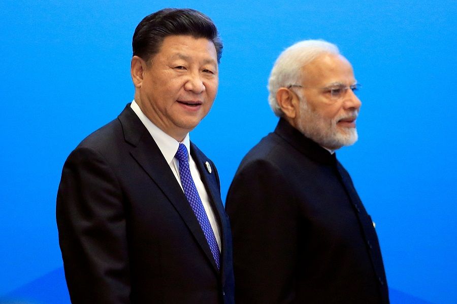 Chinese President Xi Jinping and Indian Prime Minister Narendra Modi arrive for a signing ceremony during the Shanghai Cooperation Organisation (SCO) summit in Qingdao, Shandong province, China, 10 June 2018. (Aly Song/File Photo/Reuters)