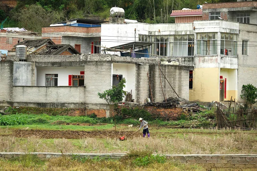 A farmer works a field at Langnan village in Wuzhou, Guangxi Zhuang Autonomous Region, on 22 March 2022. (Noel Celis/AFP)