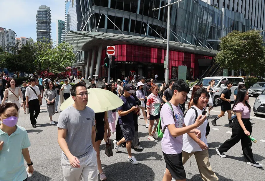 People cross a road in Singapore. (SPH Media)