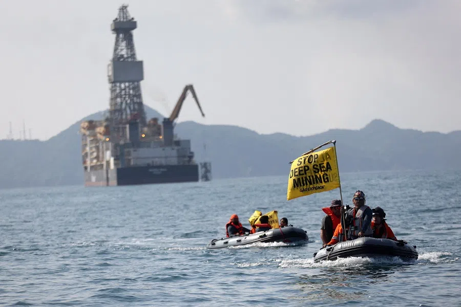 Greenpeace activists hold banners during a protest against the deep-sea mining vessel Hidden Gem, commissioned by Canadian miner The Metals Company, in the Mexican Pacific port of Manzanillo, in Manzanillo, Mexico, on 27 September 2023. (Gustavo Graf/Greenpeace Mexico/Handout via Reuters)
