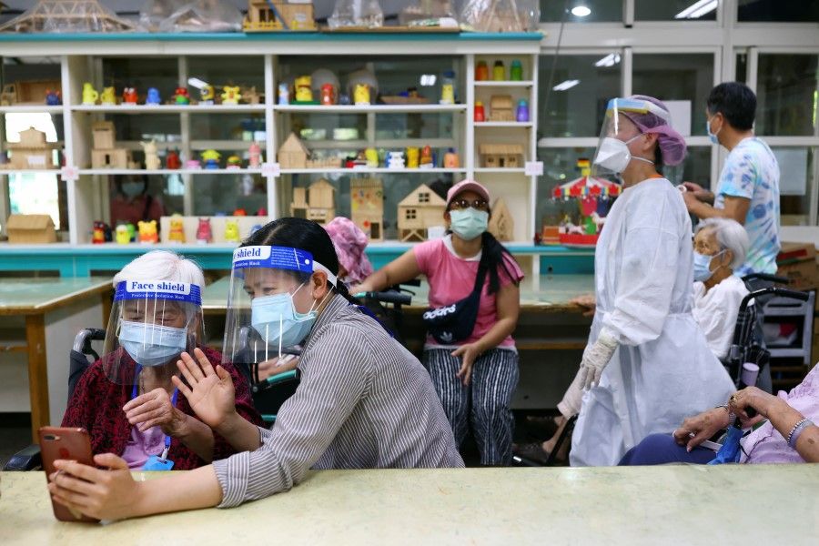 People wait during a vaccination session for elderly people over 85 years old at a school following the coronavirus disease (COVID-19) outbreak in Taipei, Taiwan, 15 June 2021. (Ann Wang/Reuters)
