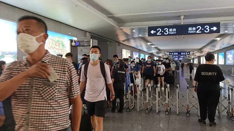 Commuters exiting Qinhuangdao train station following a security check, August 2020. (SPH)