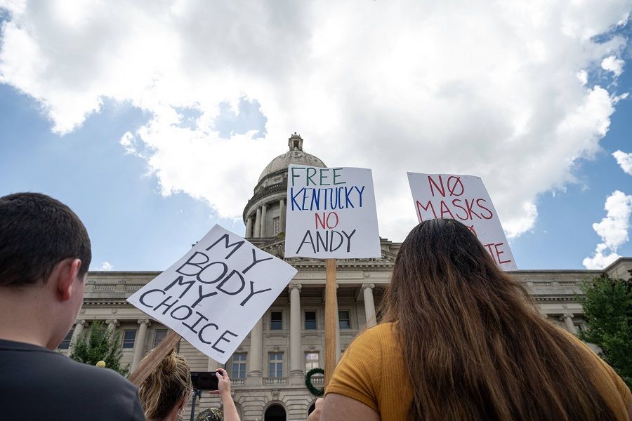 People display anti-Covid-19 mandate signs during the Kentucky Freedom Rally at the capitol building on 28 August 2021 in Frankfort, Kentucky, US. (Jon Cherry/Getty Images/AFP)