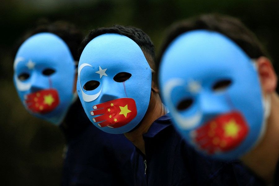 Activists take part in a protest against China's treatment towards the ethnic Uighur people and calling for a boycott of the 2022 Winter Olympics in Beijing, at a park in Jakarta, Indonesia, 4 January 2022. (Willy Kurniawan/Reuters)