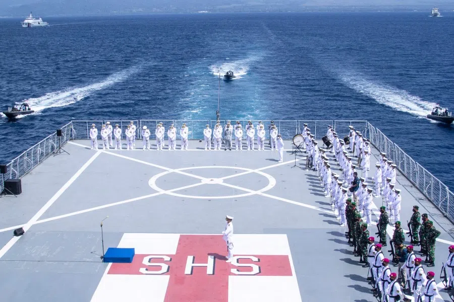 Indonesia Navy personnel take part in a ceremony before a tribute for the sunken KRI Nanggala-402 submarine crew members from the deck of KRI Dr. Soeharso-990 in the northern waters of the island of Bali, Indonesia, 30 April 2021. (Prasto Wardoyo/Reuters)