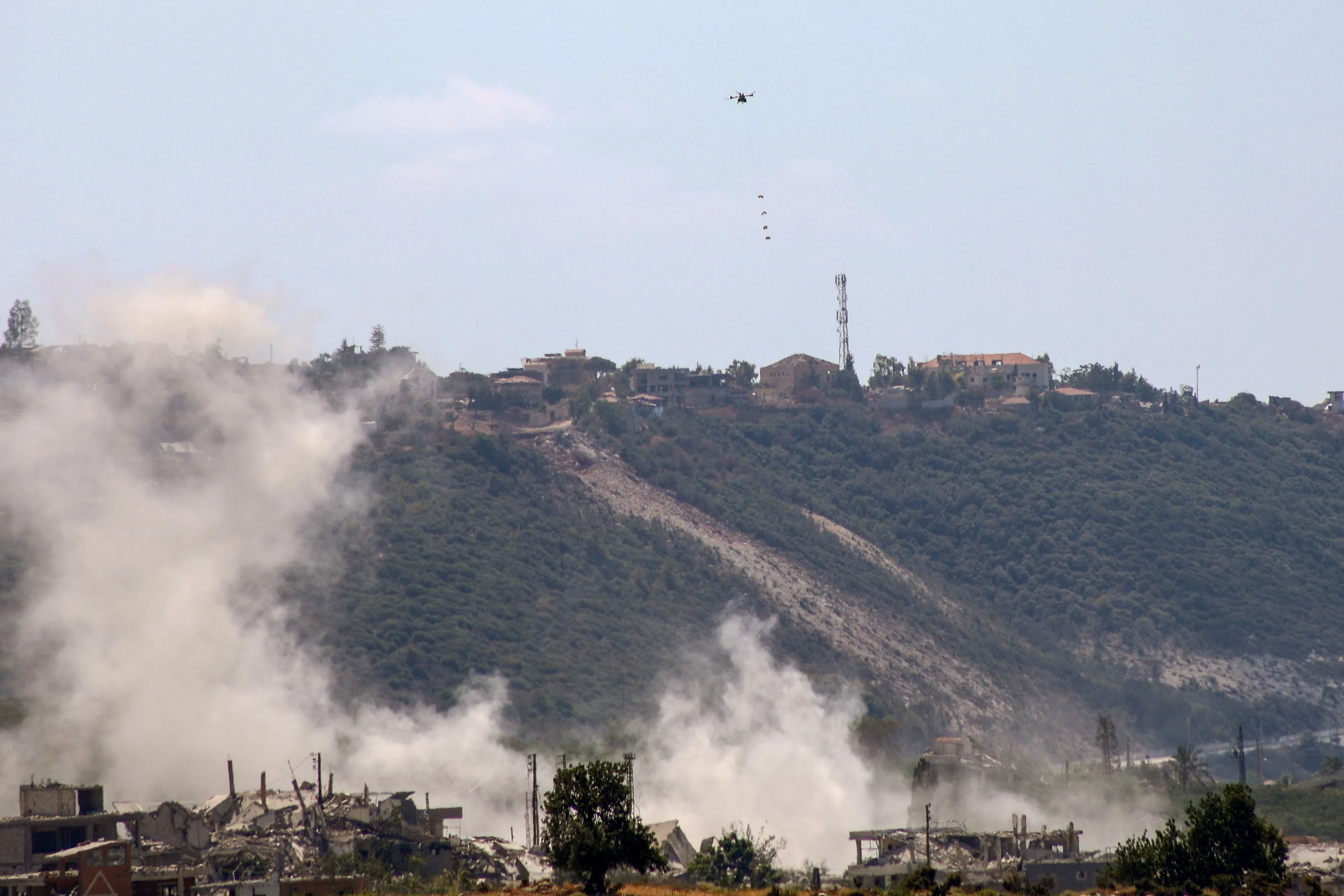 This photograph taken from the southern Lebanese village of al-Haniyya shows an Israeli drone dropping explosive charges on a site at the village of al-Mansouri on 10 September 2026.