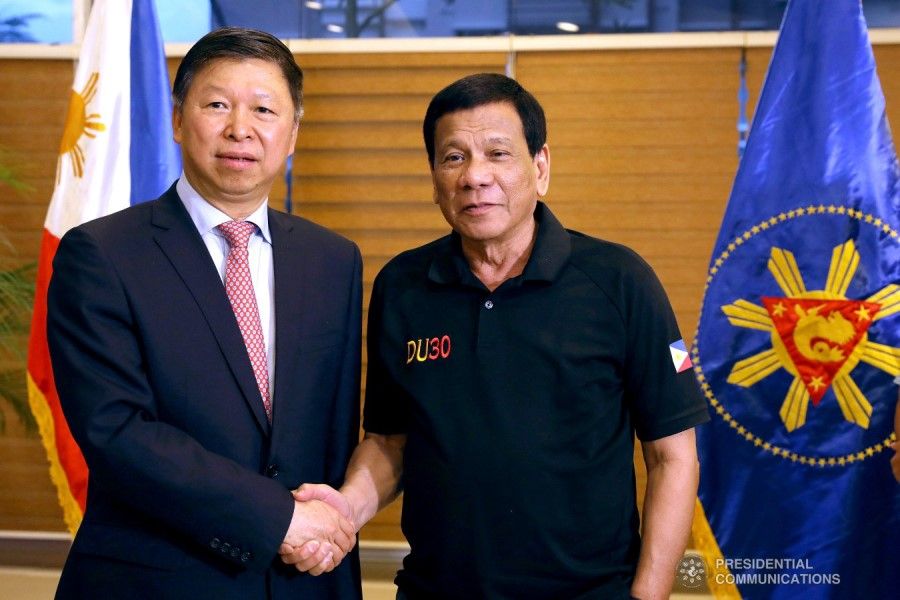 President Rodrigo Duterte (right) poses for posterity with Song Tao, head of the International Department of the Communist Party of China Central Committee, who paid a courtesy call on the president at Matina Enclaves in Davao City on 27 March 2019. (Karl Norman Alonoz for the Philippines Presidential Communications Operations Office)