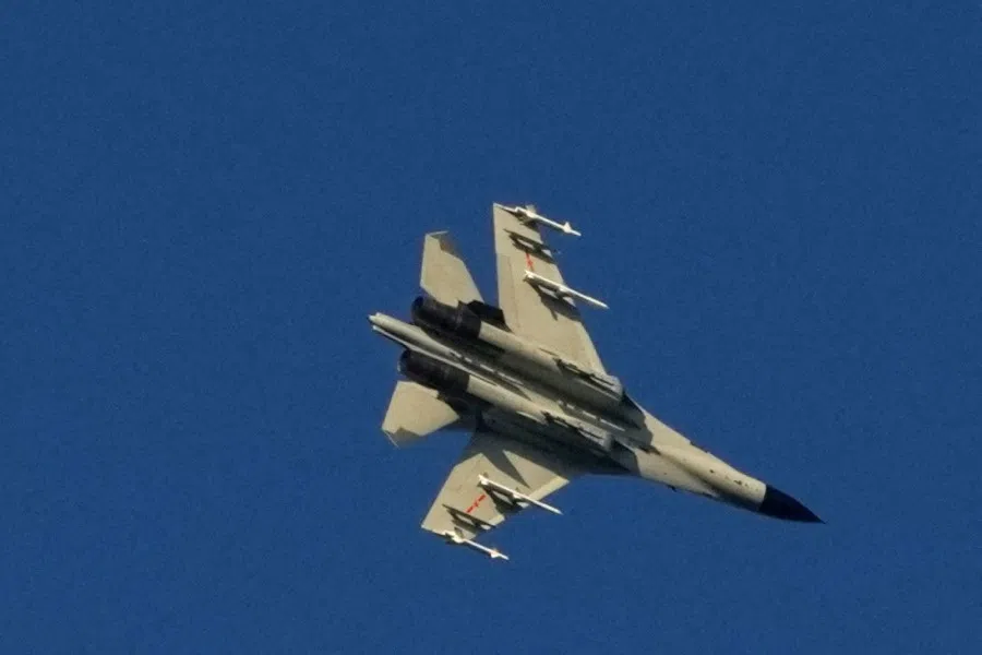 A Chinese People's Liberation Army (PLA) aircraft flies over the 68-nautical-mile scenic spot, one of mainland China's closest points to the island of Taiwan, in Pingtan island, Fujian province, China, 5 August 2022. (Aly Song/Reuters)