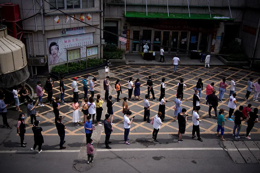 In this file photo, residents line up for nucleic acid testing at a residential compound in Wuhan, the epicentre of the Covid-19 outbreak, Hubei province, China, 15 May 2020. (Aly Song/File Photo/Reuters)