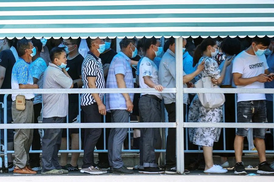 Residents queue to receive nucleic acid tests for the Covid-19 coronavirus in Nanjing, Jiangsu province, China, on 21 July 2021. (STR/AFP)
