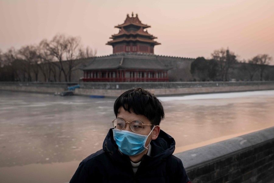 A man stands against a deserted Forbidden City in the background. The Chinese government has closed the Forbidden City and a section of the Great Wall, as well as cancelled public events and shut public venues such as cinemas, in an effort to control the spread of the Wuhan coronavirus. (Nicolas Asfouri/AFP)