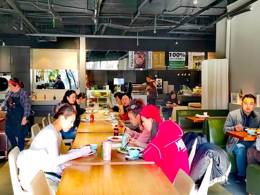 People eat at the staff canteen of the Chinese Coal Mine Art Troupe in Beijing.