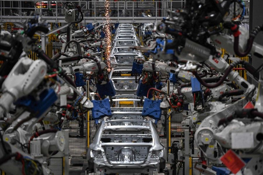 This file photo taken on 26 August 2022 shows vehicles being constructed on an automated production line at the VinFast electric automobile plant in Haiphong. (Nhac Nguyen/AFP)