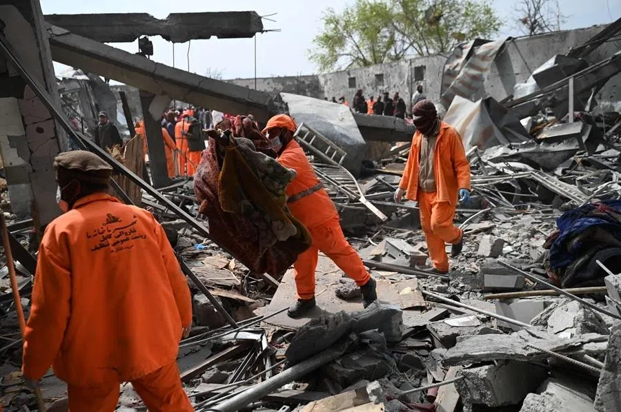 Afghan municipality workers clear debris from the site after Pakistani airstrikes hit the Omid Addiction Treatment Hospital in Kabul on 17 March 2026.