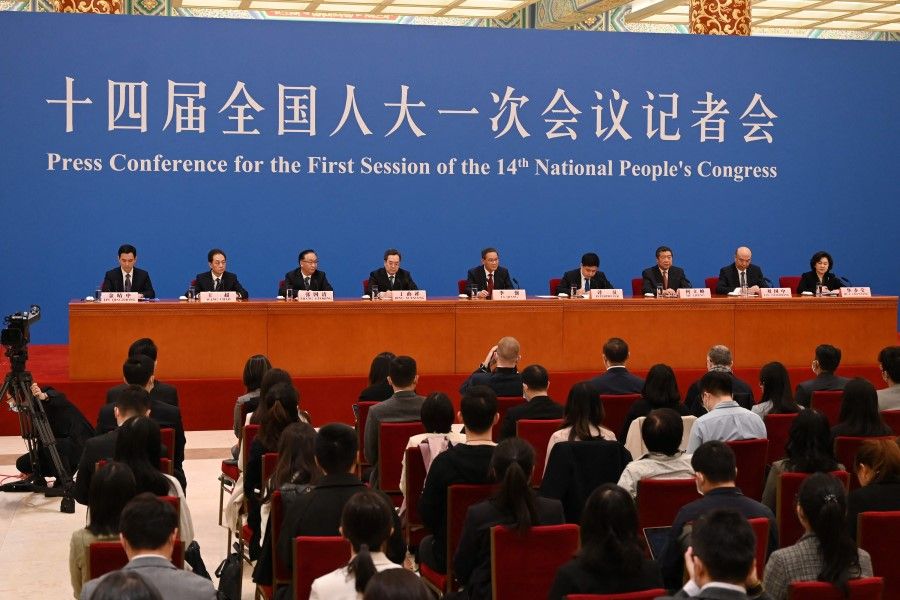 China's Premier Li Qiang (centre) along with Vice-Premiers Zhang Guoqing (3rd L), Ding Xuexiang (4th L), He Lifeng (3rd R) and Liu Guozhong (2nd R) attend a press conference after the closing session of the National People's Congress (NPC) at the Great Hall of the People in Beijing on 13 March 2023. (Greg Baker/AFP)