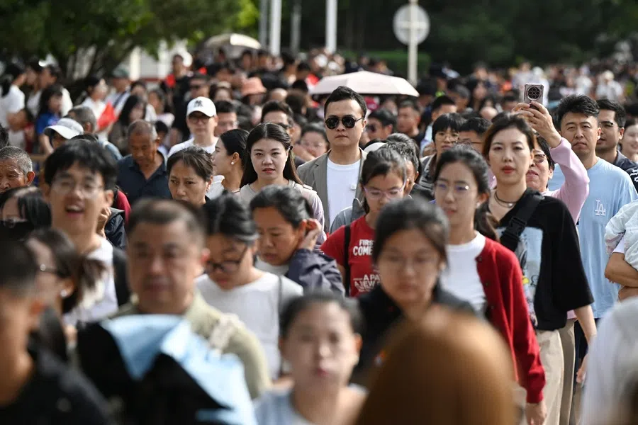 Crowds walk towards Tiananmen Square on China's National Day, which marks the 76th anniversary of the founding of the People's Republic of China, in Beijing on 1 October 2025. (Greg Baker/AFP)