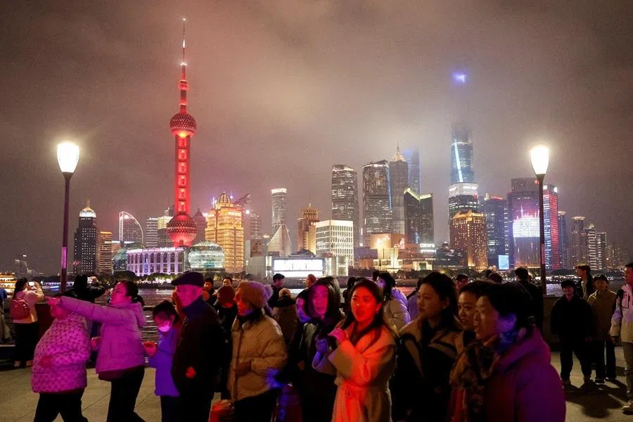 People walk on the Bund, with the Lujiazui financial district in the background, in Shanghai, China, on 28 February 2026. (Go Nakamura/Reuters)
