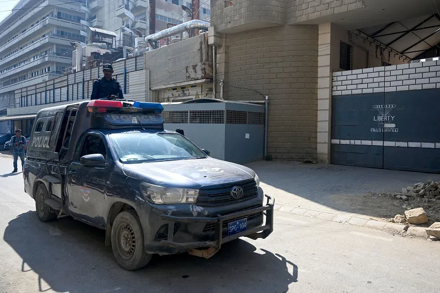 Pakistan policemen stand guard outside a factory where two Chinese nationals were allegedly shot, in Karachi on 5 November 2024. (Rizwan Tabassum/AFP)