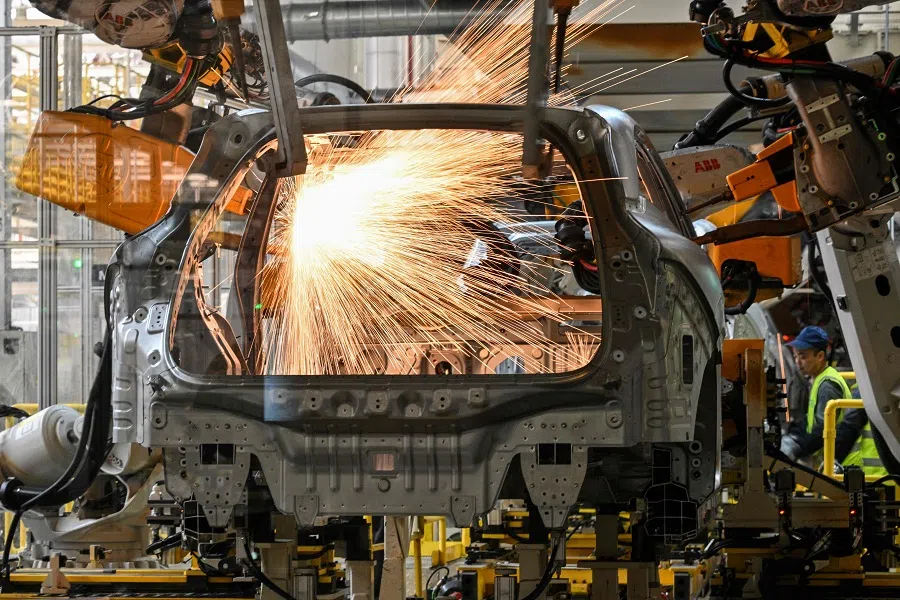 Robots weld chassis of electric cars at a Zeekr factory in Meishan Island in Ningbo, Zhejiang province, China, on 18 April 2025. (Hector Retamal/AFP)