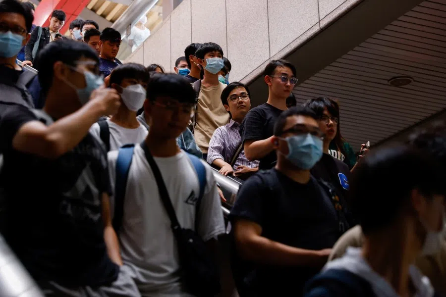 People exit a metro station in Taipei, Taiwan, 19 August 2023. (Ann Wang/Reuters)