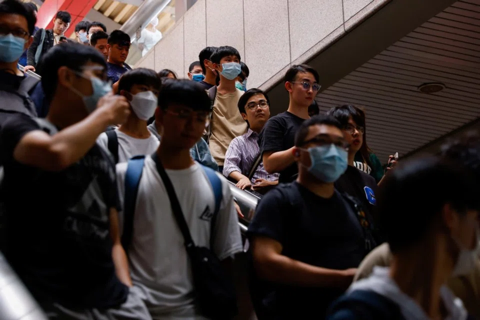 People exit a metro station in Taipei, Taiwan, 19 August 2023. (Ann Wang/Reuters)