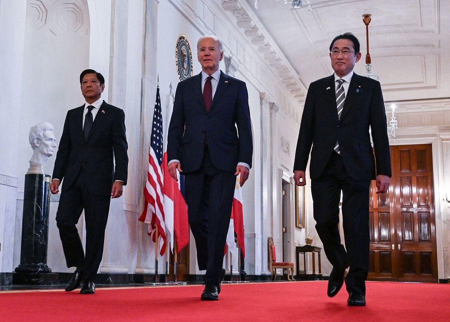 US President Joe Biden heads to a trilateral meeting with Japanese Prime Minister Fumio Kishida (right) and Filipino President Ferdinand Marcos Jr. (left) at the White House in Washington, DC, on 11 April 2024. (Andrew Caballero-Reynolds/AFP)