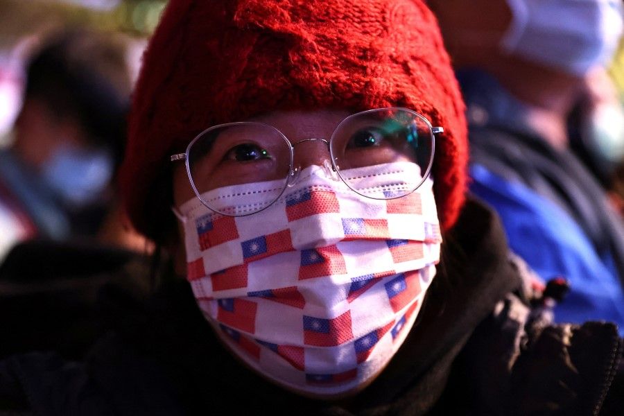 A woman wears a face mask with a Taiwan flag print during a New Year celebration in Taipei, Taiwan, 1 January 2021. (Ann Wang/REUTERS)