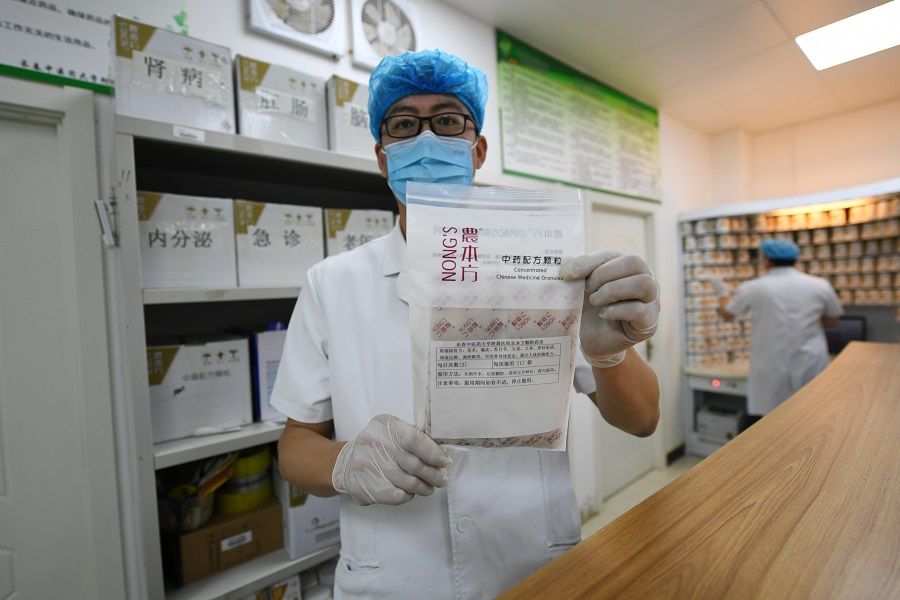 In this photo taken on 26 May 2020, a traditional Chinese medicine staff from the affiliated hospital of Changchun University of Chinese Medicine holds up a prescription used to remove dampness in the body. (Zhang Yao/CNS)