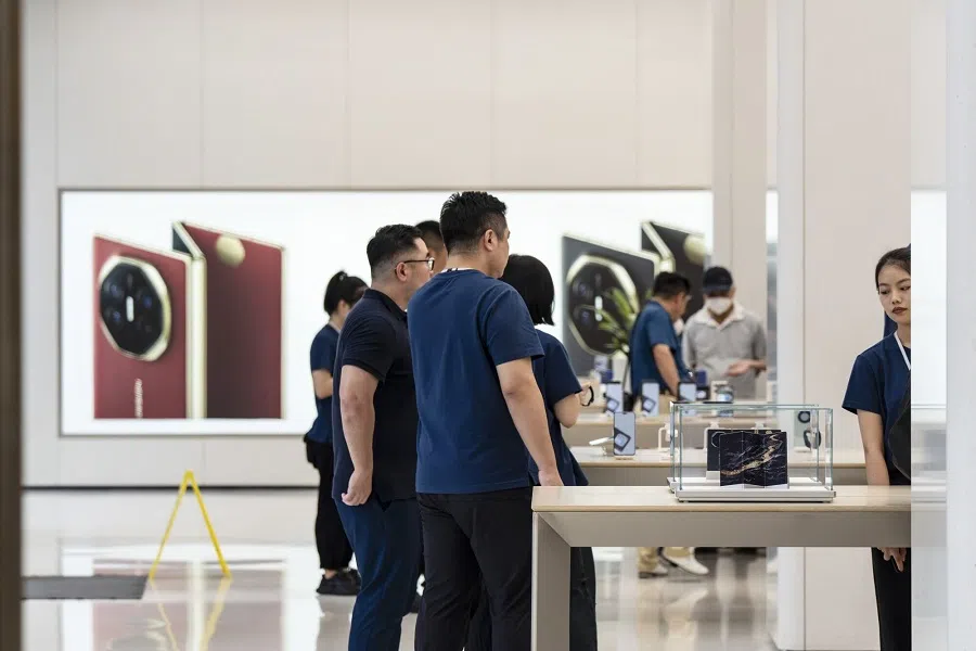 Customers look at Huawei Mate XT smartphones at one of the company’s stores in Shanghai, China, on 20 September 2024. (Qilai Shen/Bloomberg)