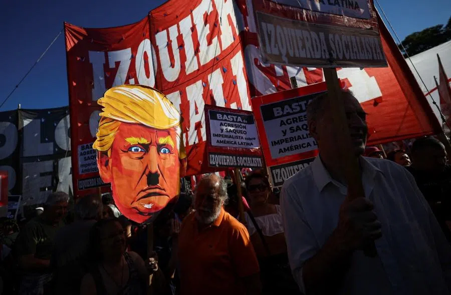 A demonstrator holds a cardboard depiction of US President Donald Trump outside the US embassy during a protest following the US attack on Venezuela that resulted in the capture of Venezuelan President Nicolas Maduro and his wife Cilia Flores, in Buenos Aires, Argentina, on 5 January 2026.