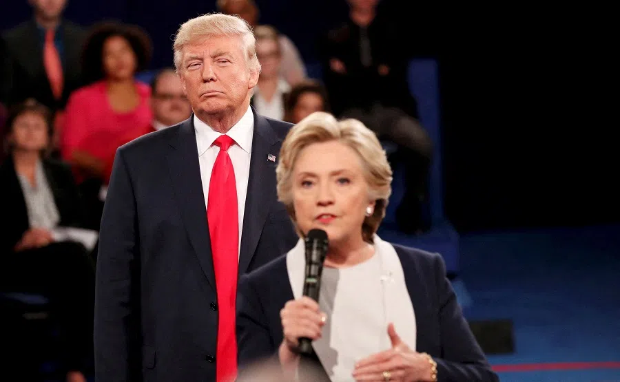 Republican US presidential nominee Donald Trump listens as Democratic nominee Hillary Clinton answers a question from the audience during their presidential town hall debate at Washington University in St. Louis, Missouri, US, on 9 October 2016. (Rick Wilking/Reuters)