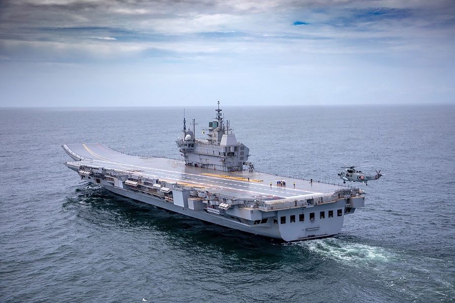 In this handout photo taken on 4 August 2021 and released by the Indian Navy, the Indigenous Aircraft Carrier (IAC P71) 'Vikrant' sets out as it commenced its sea trials from the naval dockyard in Kochi, India. (Indian Navy/AFP)