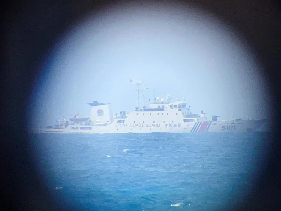 A China Coast Guard ship on the horizon through a telescopic view in Philippine-occupied Thitu Island in the disputed South China Sea, on 21 February 2026. (Karen Lema/Reuters)