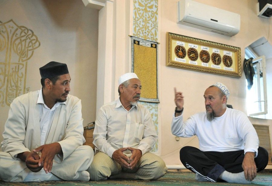 People in a mosque in Almaty on 15 July 2009, just one days drive from Urumqi in Xinjiang, where clashes between Uighurs and Han Chinese erupted on 5 July 2009. (Pavel Mikheev/Reuters)