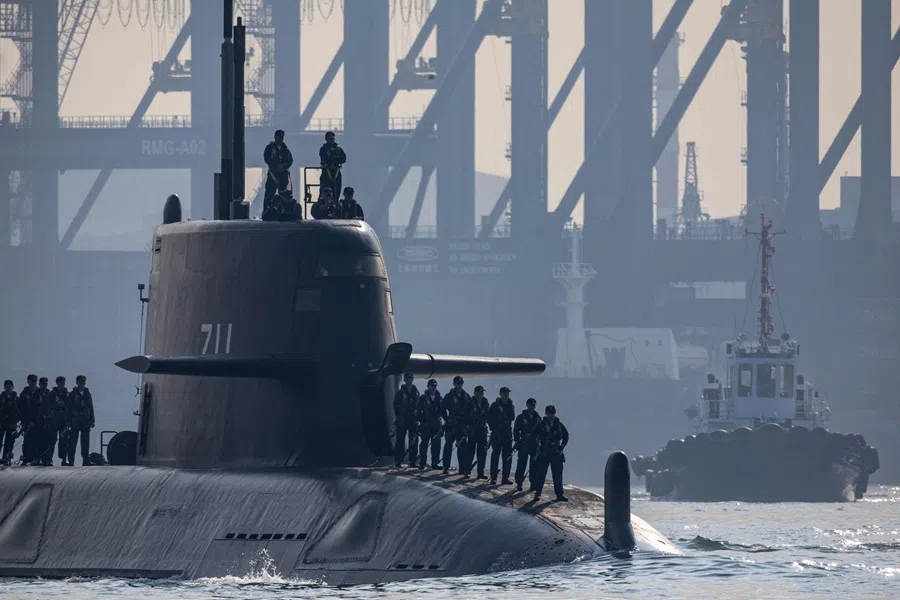 The Taiwan Navy's prototype submarine Hai Kun (SS-711) navigates out towards open waters escorted by a harbor tugboat in Kaohsiung Port during sea testing operations off Kaohsiung, Taiwan, on 13 October 2026.