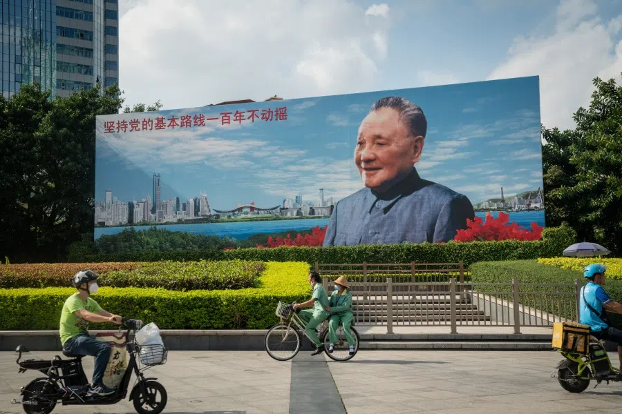 Cyclists and motorcyclists ride through Deng Xiaoping Portrait Square in Shenzhen, China, on 20 November 2020. (Yan Cong/Bloomberg)