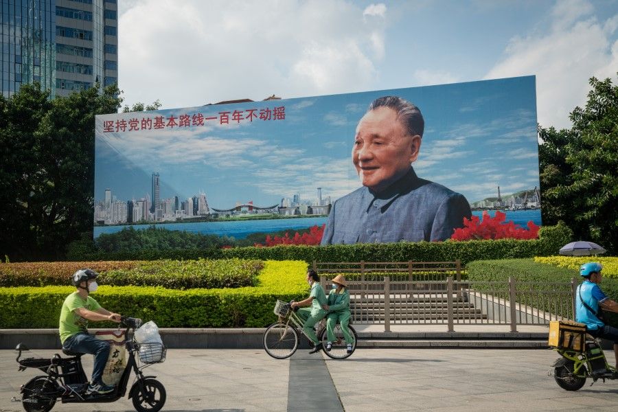 Cyclists and motorcyclists ride through Deng Xiaoping Portrait Square in Shenzhen, China, on 20 November 2020. (Yan Cong/Bloomberg)